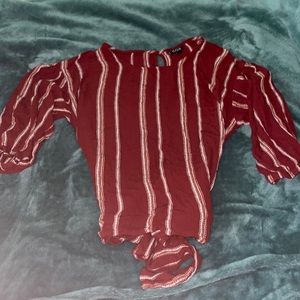 red and while puffy sleeved long sleeve with a tie